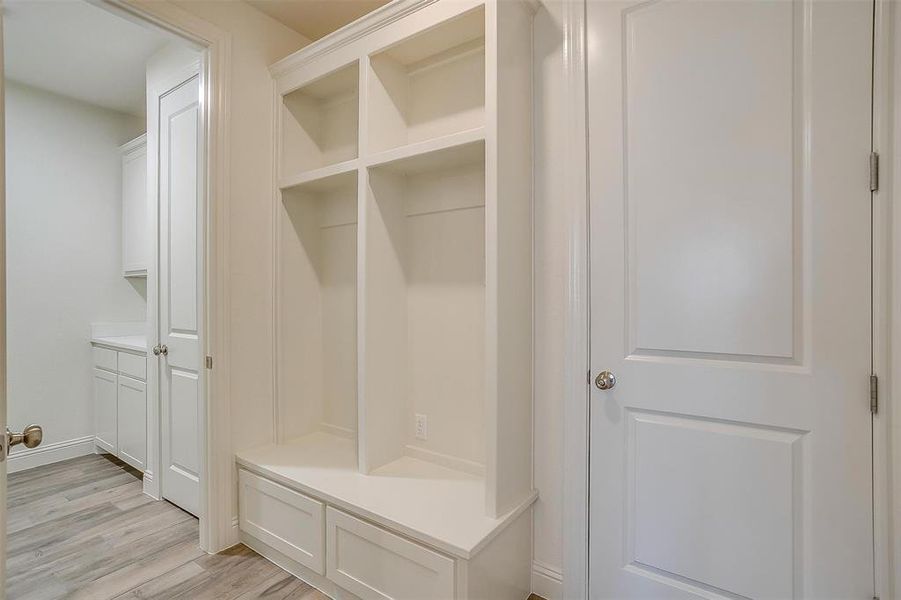 Mudroom with light hardwood / wood-style floors