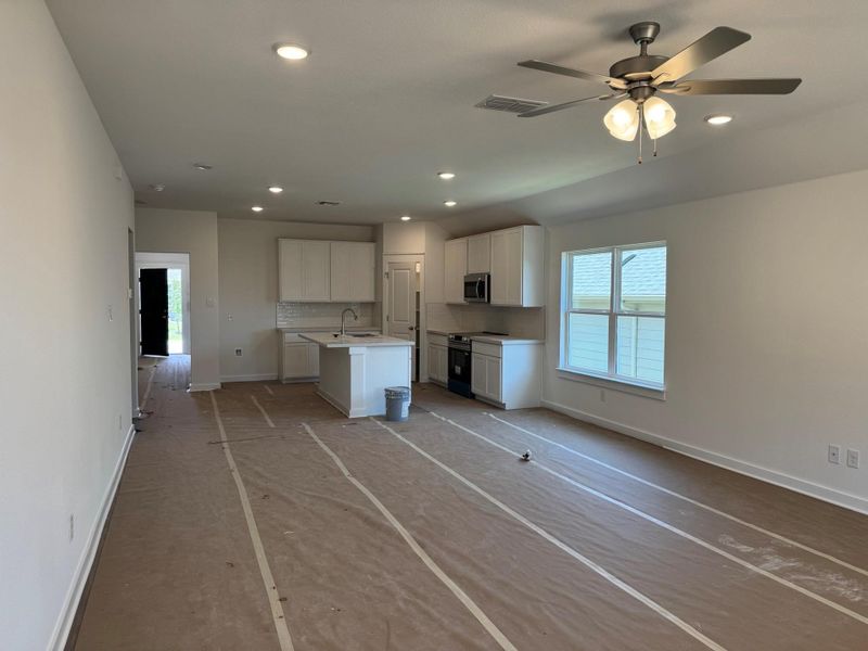 Unfurnished living room featuring healthy amount of natural light, recessed lighting, and ceiling fan Unfurnished living room featuring healthy amount of natural light, recessed lighting, and ceiling fan