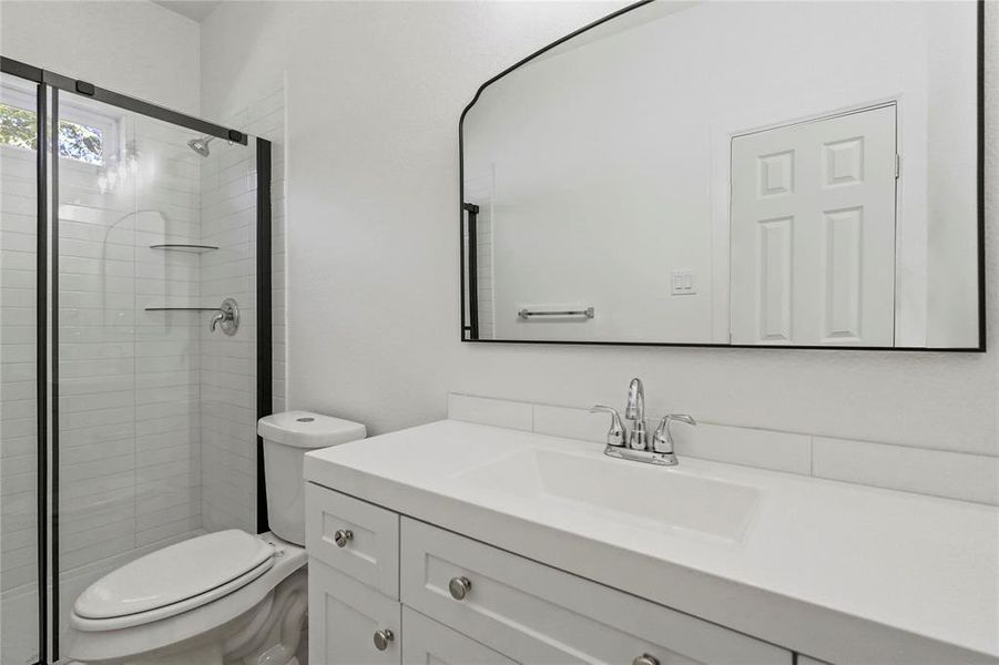 Bathroom with vanity and a stall shower
