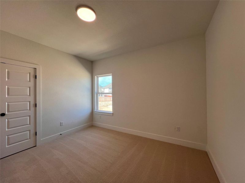Unfurnished room featuring light colored carpet and baseboards