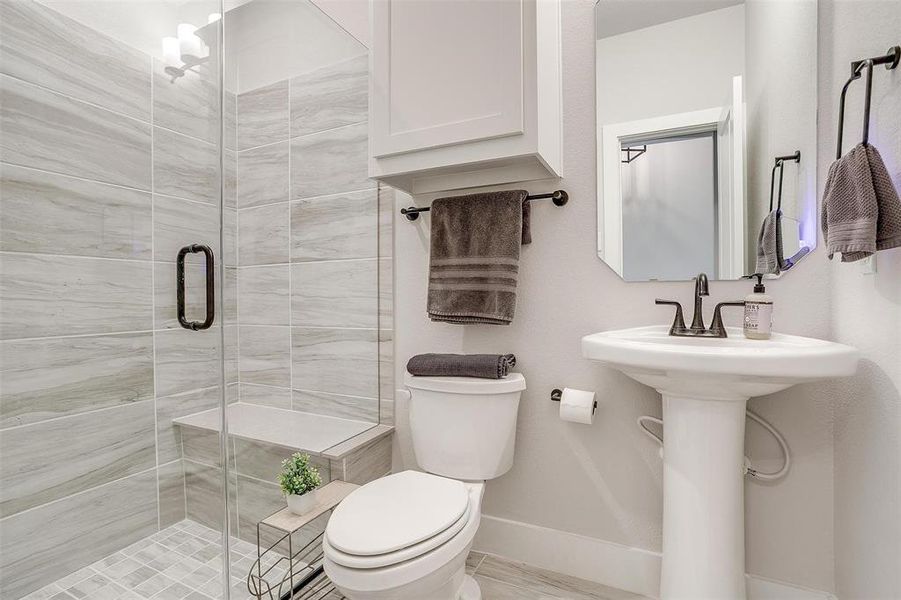 Full bathroom with luxurious shower ready for guests and in close proximity to large secondary bedroom