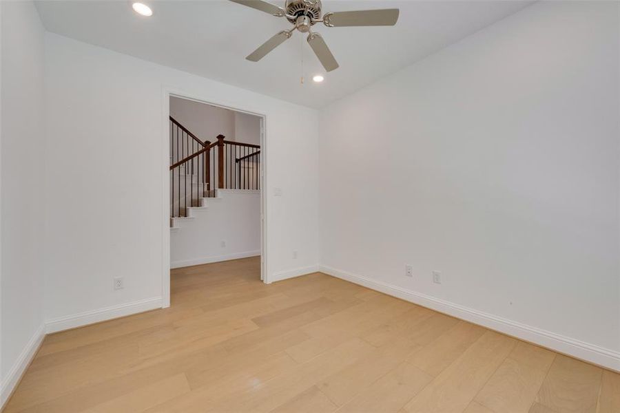 Empty room featuring ceiling fan and light hardwood / wood-style flooring