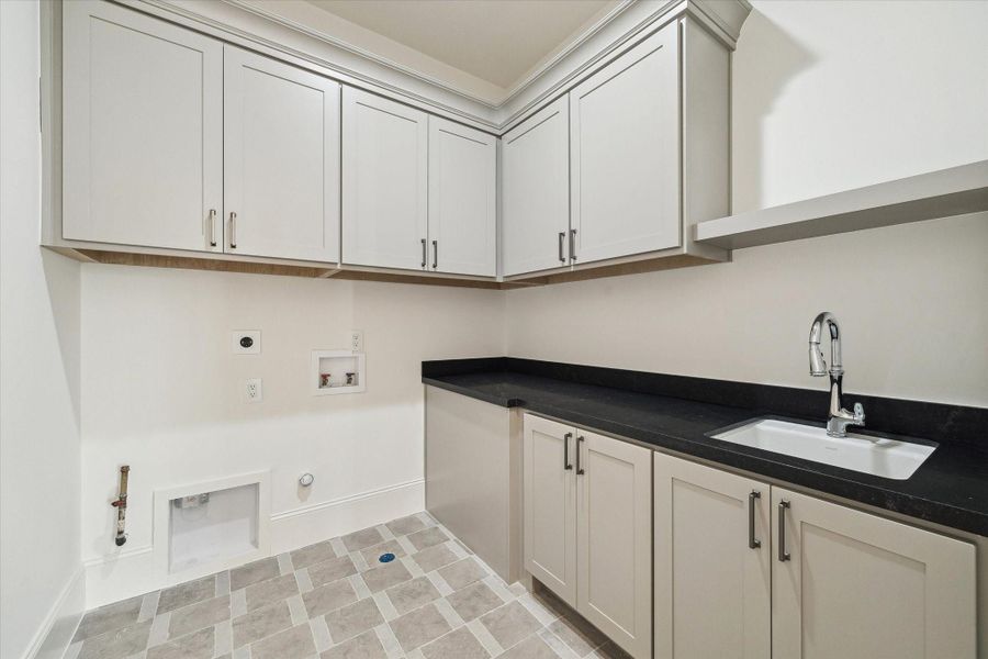 Utility room included on the second floor with plenty of built-in storage, along with Kohler Park Falls enameled cast iron undermount utility sink and Kohler Simplice compact faucet.