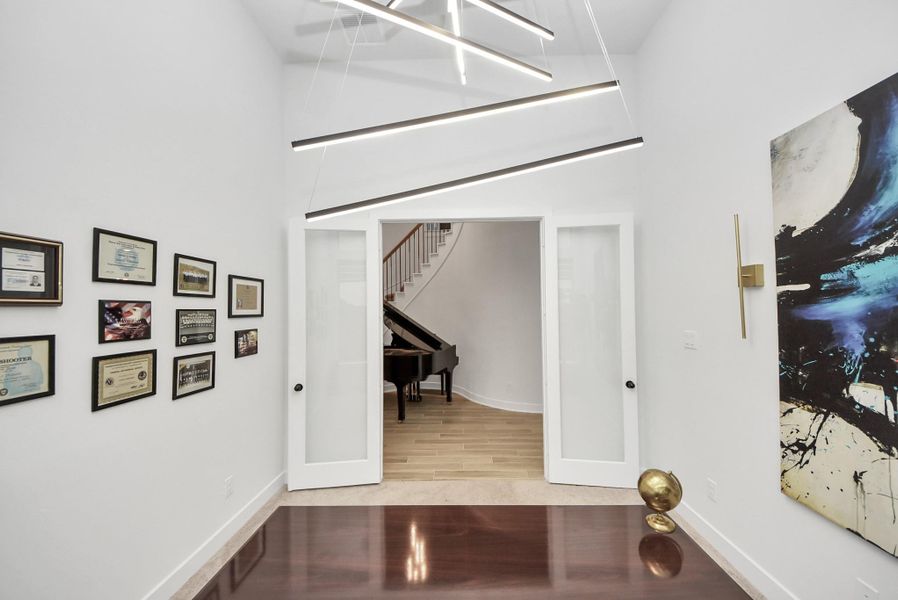 Study with glass French doors opening to foyer.