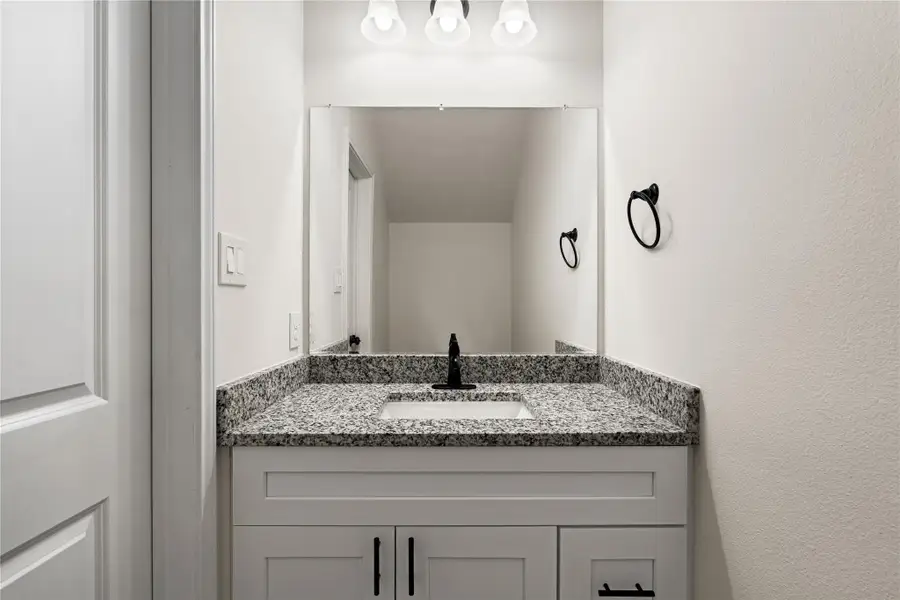 A well-placed half bath tucked under the stairs, offering added convenience for everyday use and entertaining.