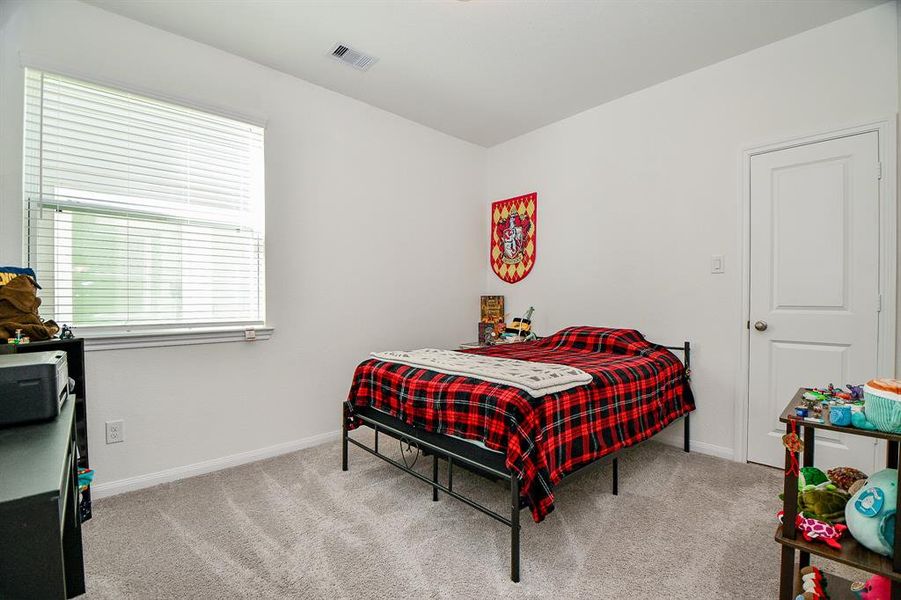 With three very spacious bedrooms, you will always have room for company. This secondary bedroom offers plush carpet, neutral paint, a large walk-in closet and easy access to a full bathroom.