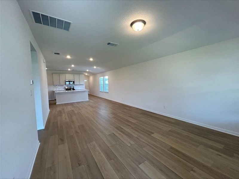 Unfurnished living room featuring wood-style floors and recessed lighting