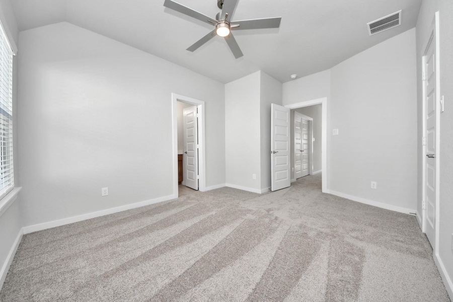 Generously sized secondary bedrooms featuring spacious closets, soft and inviting carpeting underfoot, large windows allowing plenty of natural light, and the added touch of privacy blinds for your personal retreat.