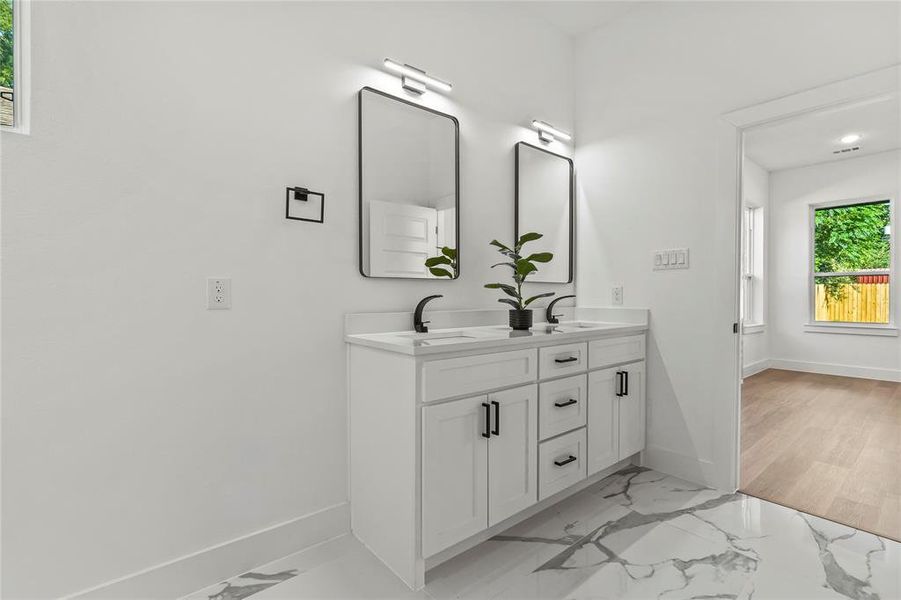 Bathroom with marble look tiles and double vanity