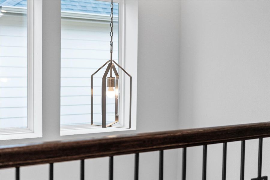 Make a statement with this contemporary geometric lantern-style pendant, offering bright, ambient lighting above the stairs.