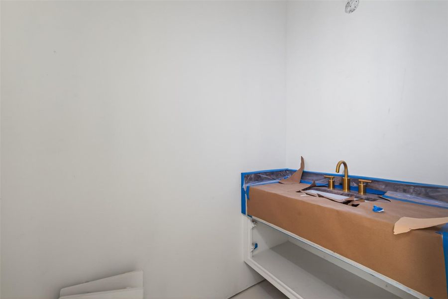 Half bath on first floor set to have a boutique hotel waterfall sink