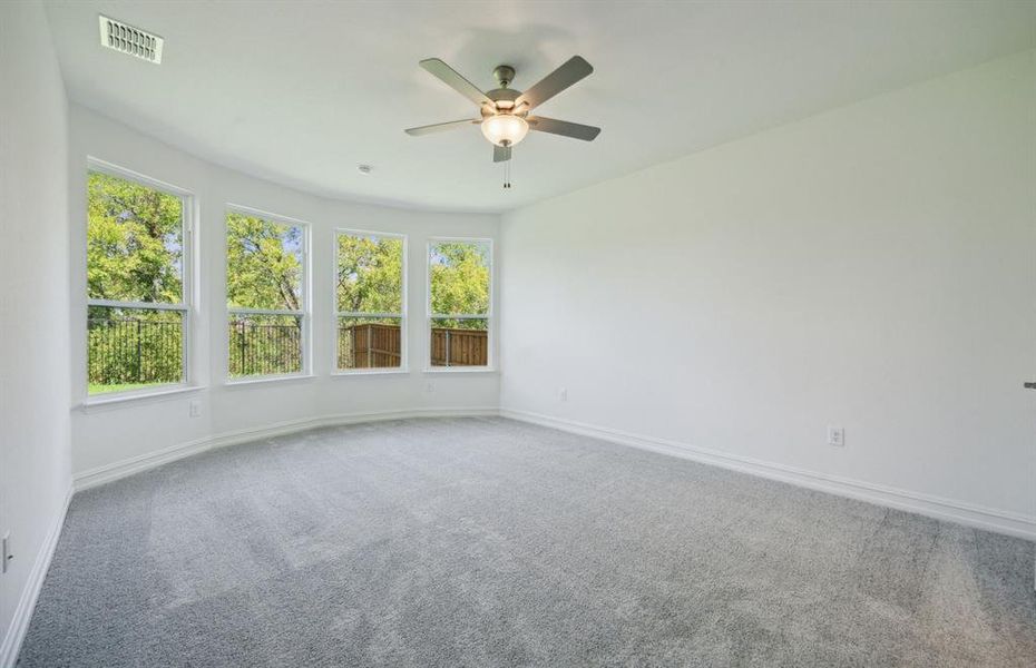 Elegant owner's suite with bay window *real home pictured