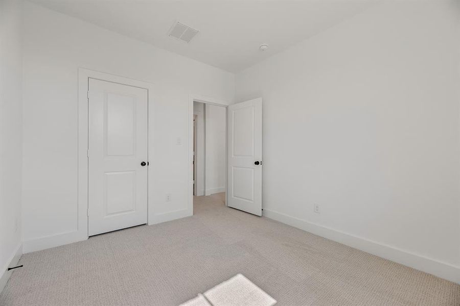 Unfurnished bedroom featuring carpet flooring and baseboards Unfurnished bedroom featuring carpet flooring and baseboards
