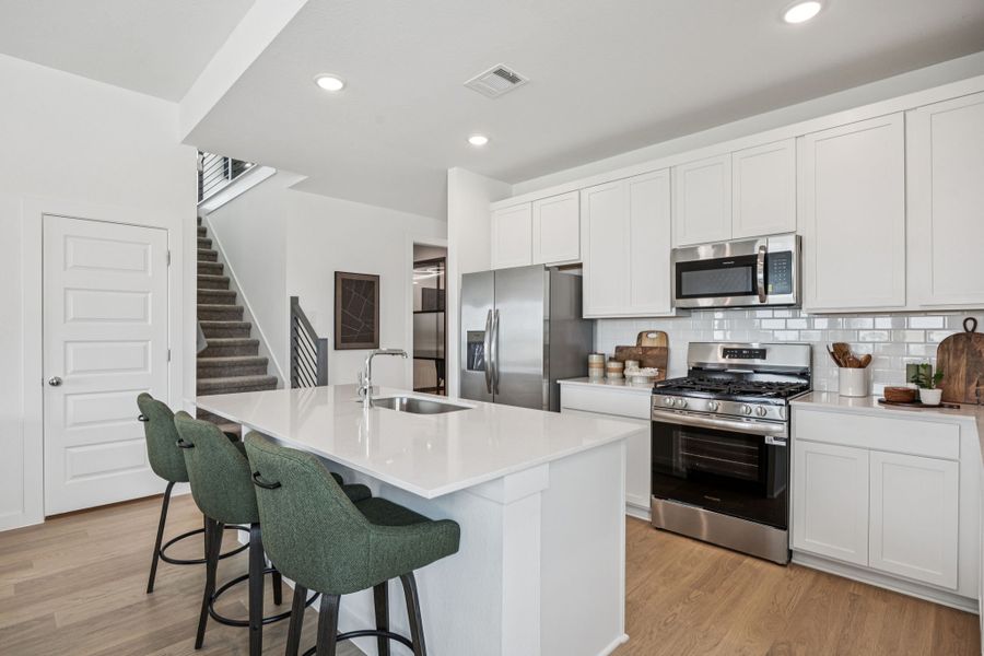 Kitchen in the Trinity home plan by Trophy Signature Homes – REPRESENTATIVE PHOTO