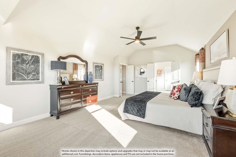 Master bedroom with vaulted ceiling, ceiling fan, carpet flooring, and dark wood dresser with mirror Master bedroom with vaulted ceiling, ceiling fan, carpet flooring, and dark wood dresser with mirror