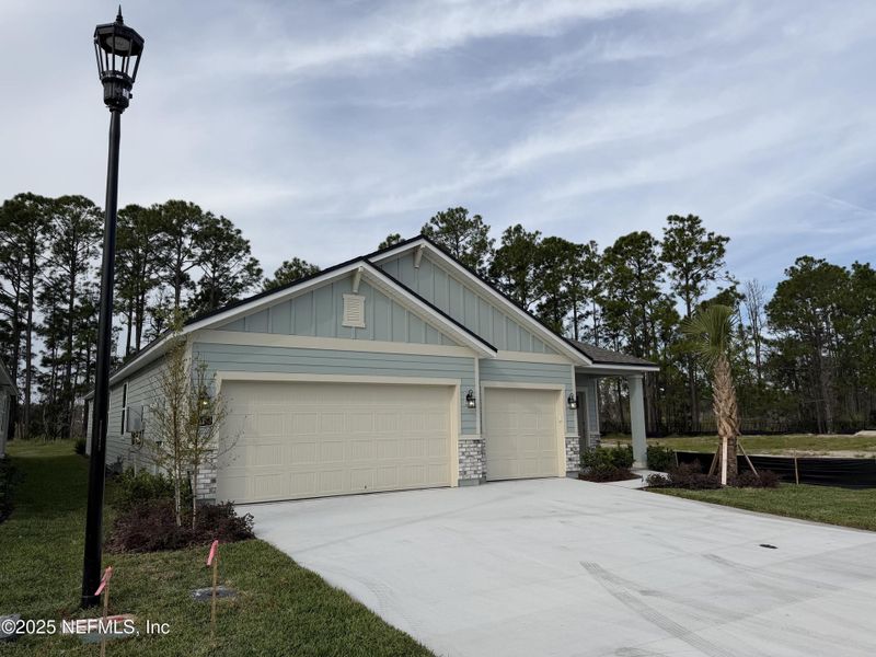 Front exterior of a new home in The Magnolia Series at Reserve East, Flagler Beach, FL, highlighting curb appeal (Image 2).