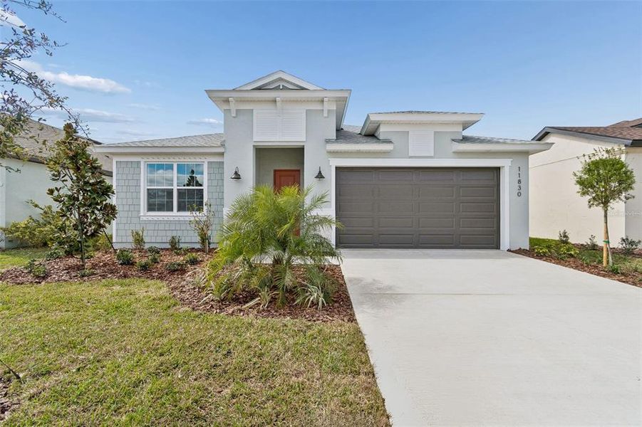 Front exterior of a new home in Isles at Bayview, Parrish, FL, highlighting curb appeal (Image 28). Front exterior of a new home in Isles at Bayview, Parrish, FL, highlighting curb appeal (Image 28).