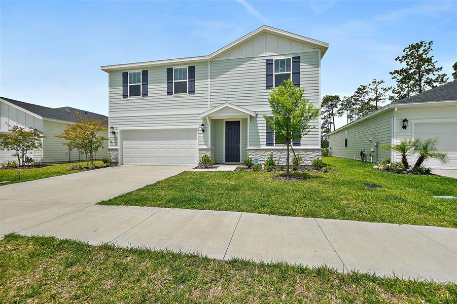 Front exterior of a new home in , Palm Coast, FL, highlighting curb appeal (Image 24). Front exterior of a new home in , Palm Coast, FL, highlighting curb appeal (Image 24).