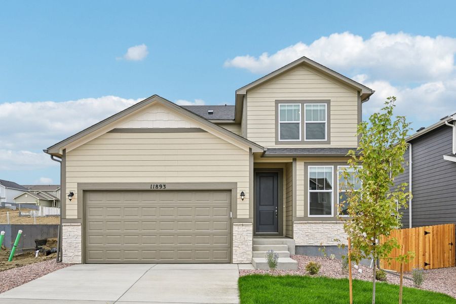 Front exterior of a new home in Ridge at Lorson Ranch, Colorado Springs, CO, highlighting curb appeal (Image 2). Front exterior of a new home in Ridge at Lorson Ranch, Colorado Springs, CO, highlighting curb appeal (Image 2).