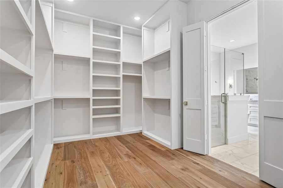 Primary closet with custom built in shelving