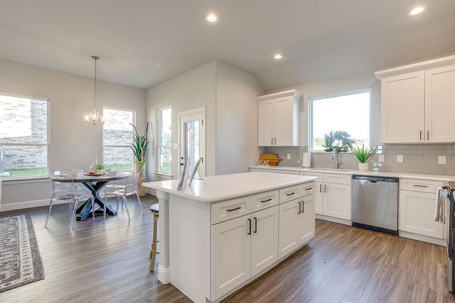 Kitchen featuring recessed lighting, backsplash, appliances with stainless steel finishes, and white cabinetry