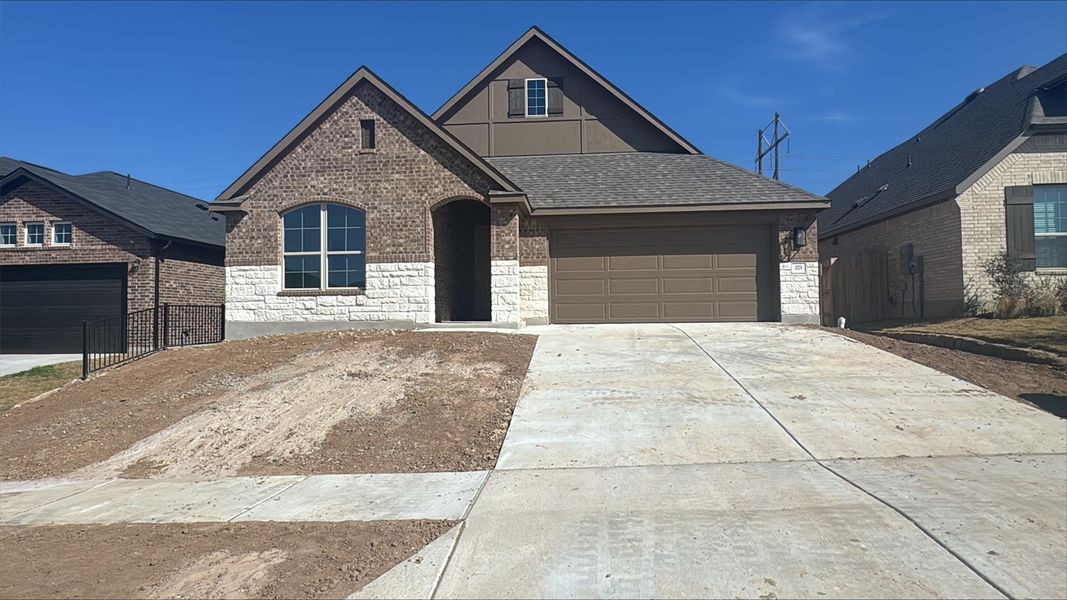 Front exterior of a new home in Sunfield, Buda, TX, highlighting curb appeal (Image 7).