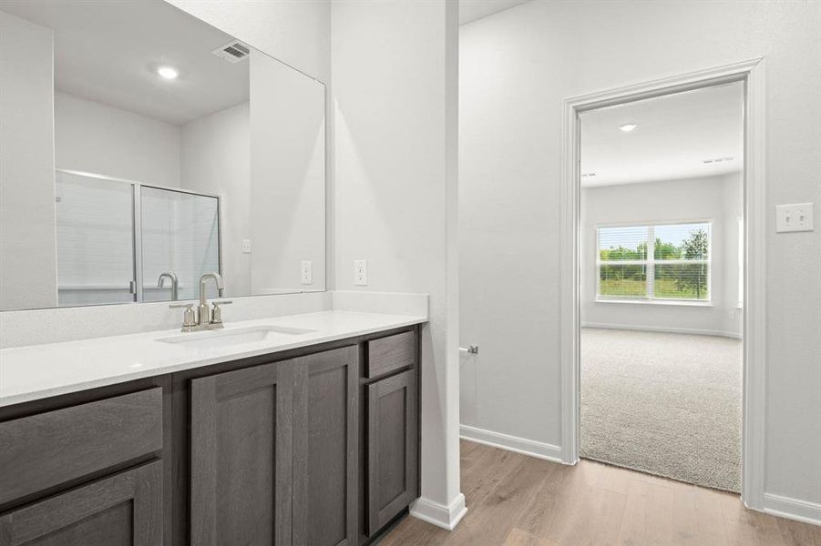 Full bathroom featuring vanity, a shower stall, light wood finished floors, and recessed lighting