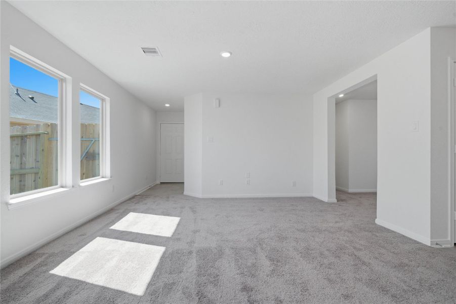 The kitchen features high ceilings, recessed lighting, gorgeous Woodmont cabinetry, stainless steel Whirlpool appliances, granite countertops, a modern backplash, and a pantry - all overlooking the Great Room.