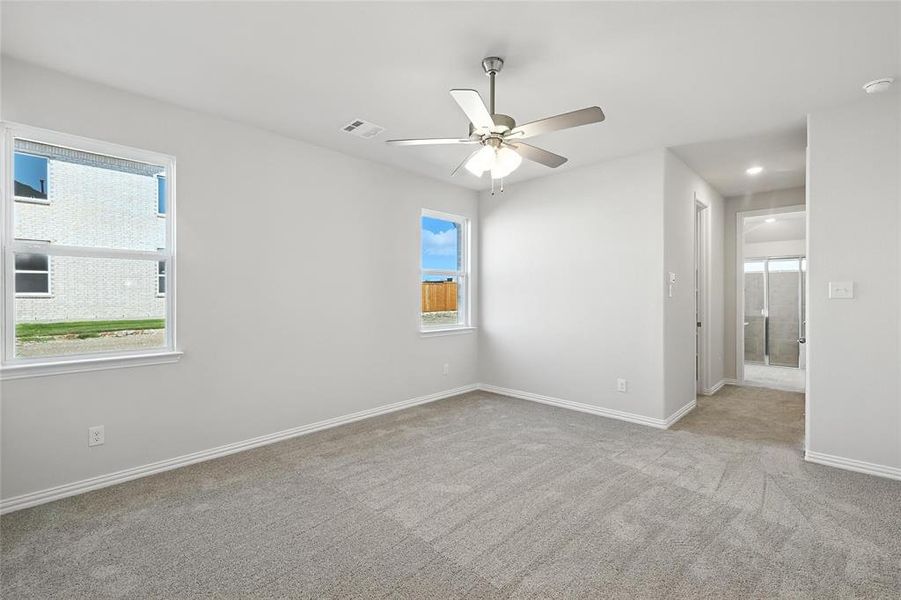 Carpeted spare room featuring a ceiling fan and a smoke detector Carpeted spare room featuring a ceiling fan and a smoke detector
