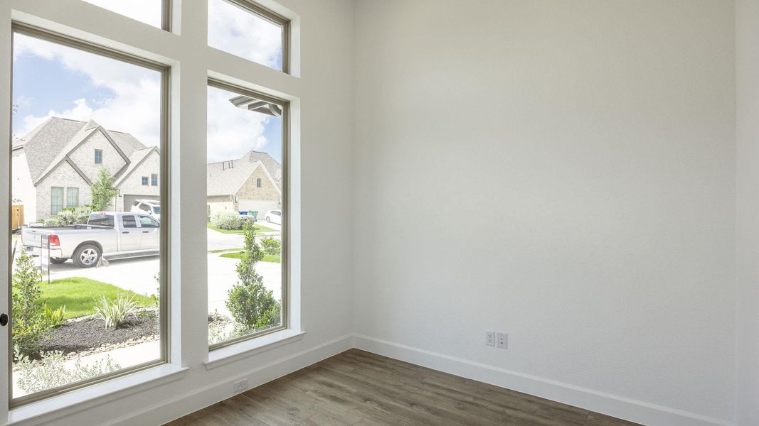 Unfurnished room with baseboards and wood finished floors Unfurnished room with baseboards and wood finished floors