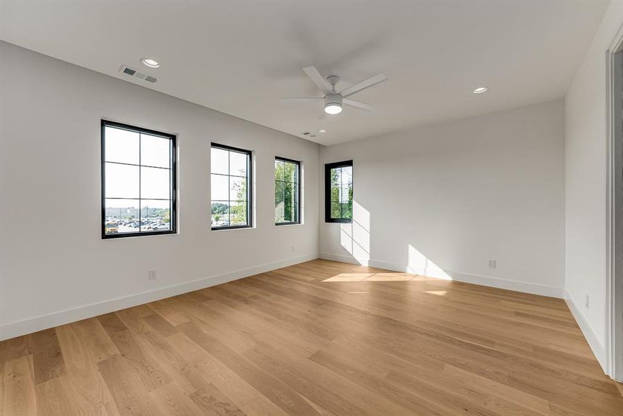Spare room with recessed lighting, light wood finished floors, and a ceiling fan Spare room with recessed lighting, light wood finished floors, and a ceiling fan