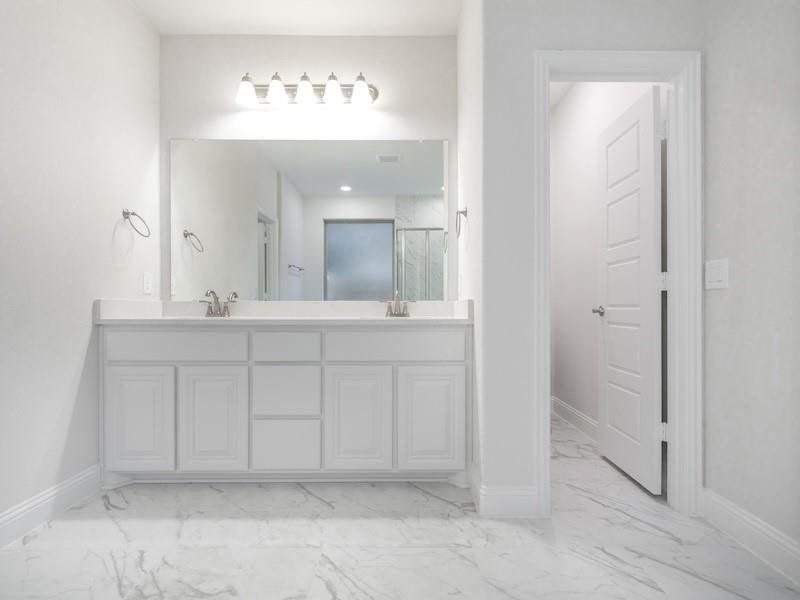 Bathroom featuring walk in shower and vanity