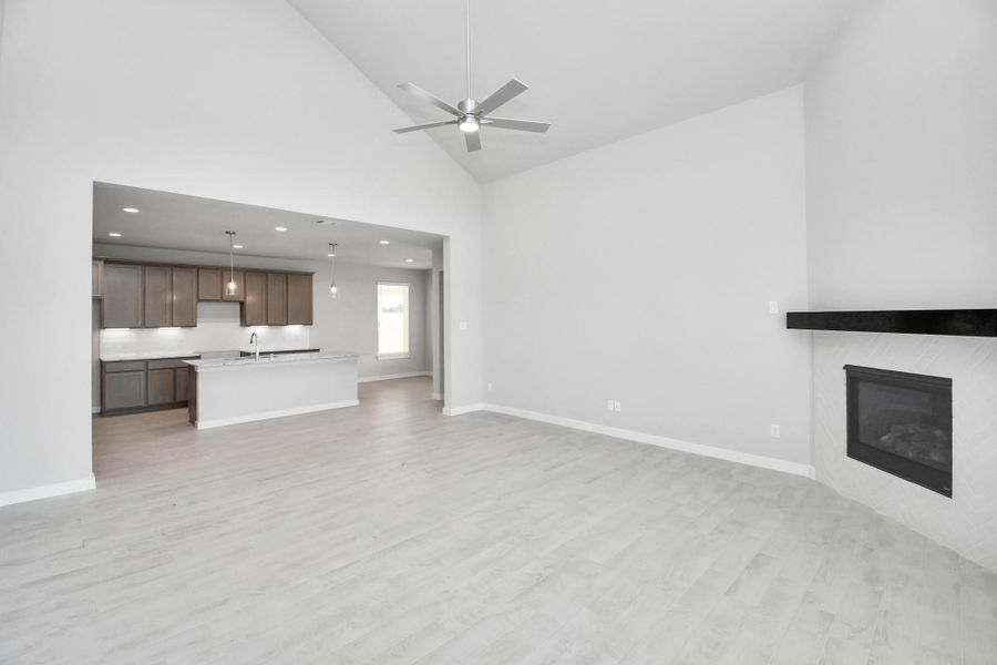 Family room flooded with natural light through the expansive windows. The premium tile flooring adds a touch of luxury to the space, creating the perfect setting for relaxing moments and cherished gatherings with loved ones. Sample photo of completed home with similar floor plan. Actual colors and selections may vary. Family room flooded with natural light through the expansive windows. The premium tile flooring adds a touch of luxury to the space, creating the perfect setting for relaxing moments and cherished gatherings with loved ones. Sample photo of completed home with similar floor plan. Actual colors and selections may vary.