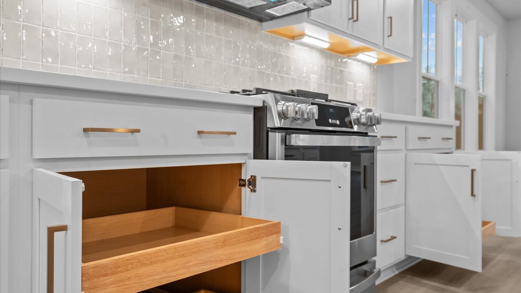 Superior kitchen with quartz countertops, pendant lighting, and a generously sized island Superior kitchen with quartz countertops, pendant lighting, and a generously sized island