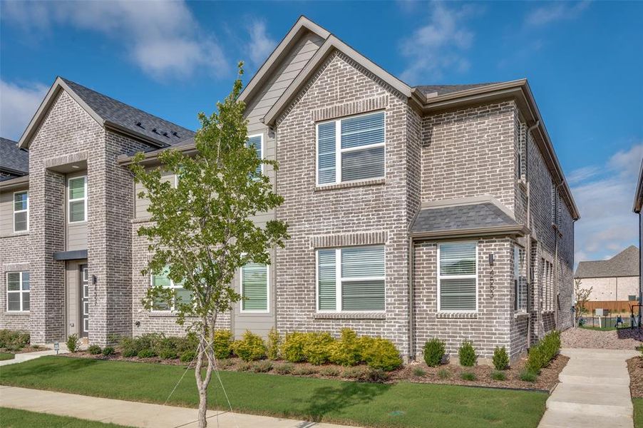 Front exterior of a new home in Mosaic, Prosper, TX, highlighting curb appeal (Image 1).