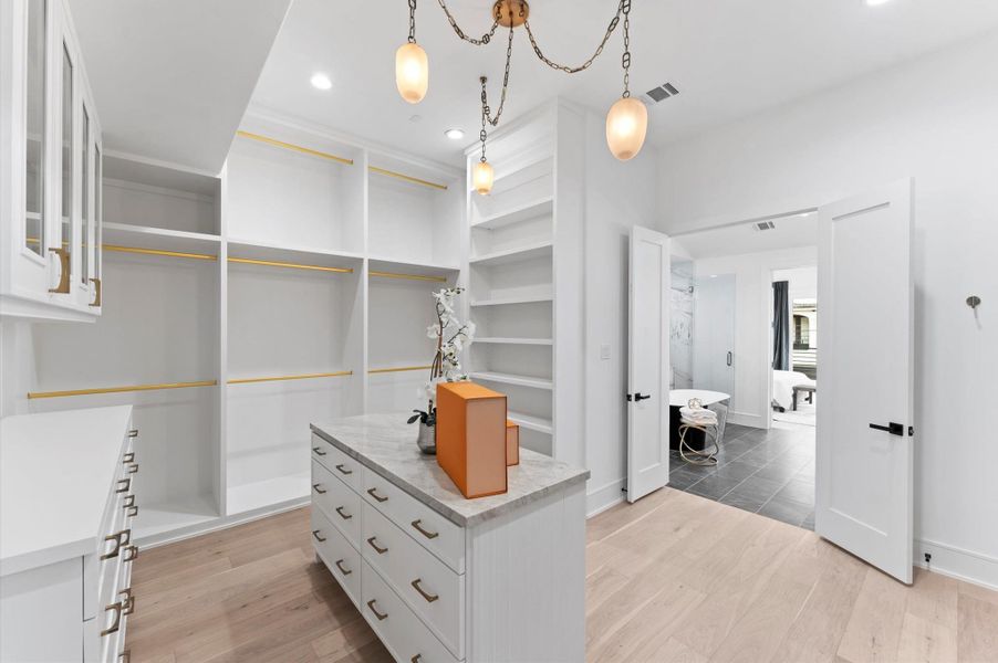 Walk in Closet with designer lighting and custom profile under island