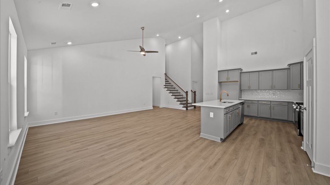 Exceptional family space featuring two-story ceilings, hardwood flooring, and tasteful finishes throughout