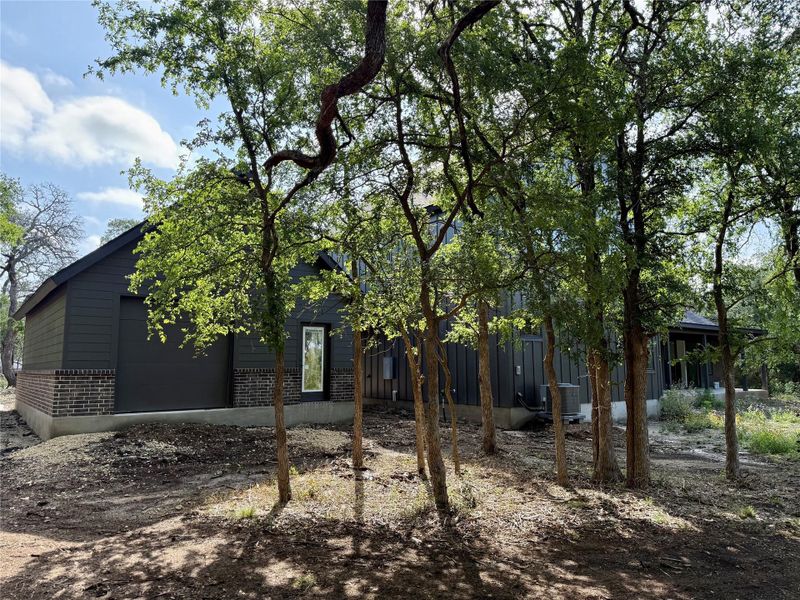 Rear view of the detached garage and grouping of trees. Rear view of the detached garage and grouping of trees.
