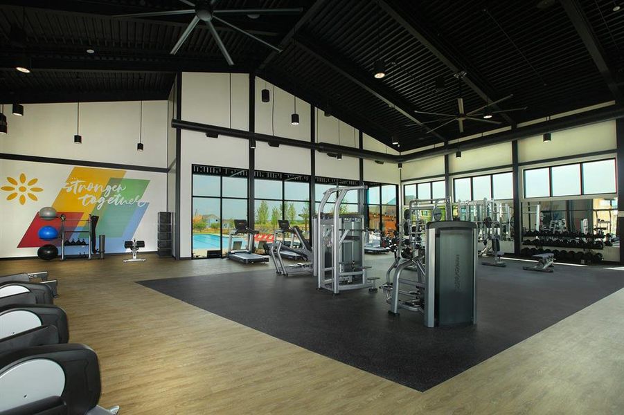 Exercise room featuring a wealth of natural light, a towering ceiling