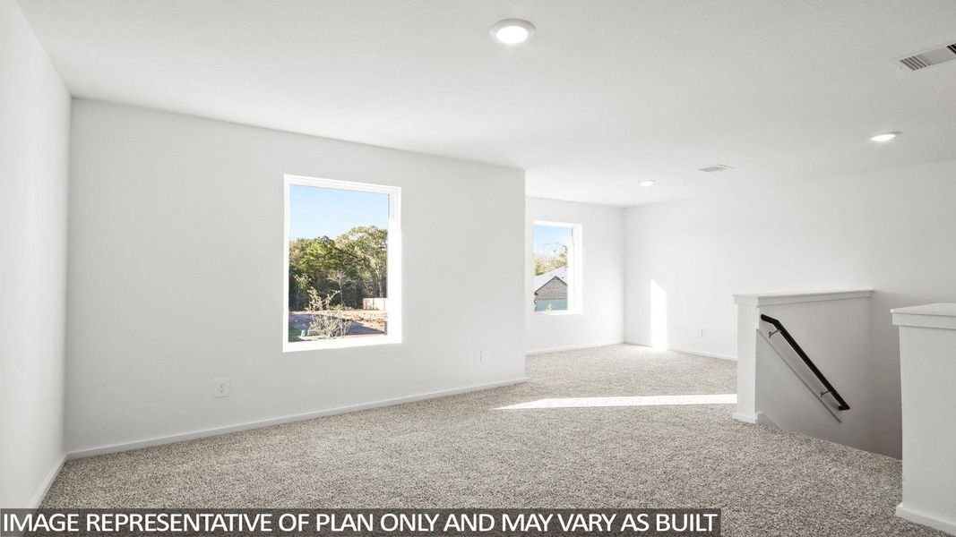 Upper-level room featuring neutral carpeting, recessed lighting, and bright white walls