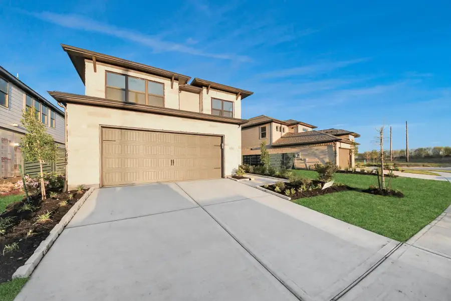 Front exterior of a new home in Austin Point, Richmond, TX, highlighting curb appeal (Image 2). Front exterior of a new home in Austin Point, Richmond, TX, highlighting curb appeal (Image 2).