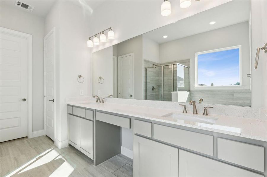 Bathroom with vanity, an enclosed shower, and hardwood / wood-style flooring