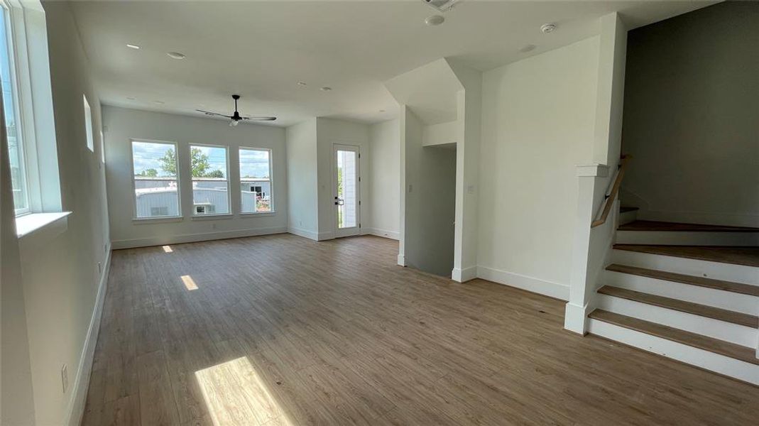 The room extends toward a patio door with a view outdoors, suggesting a blend of comfort and contemporary design.