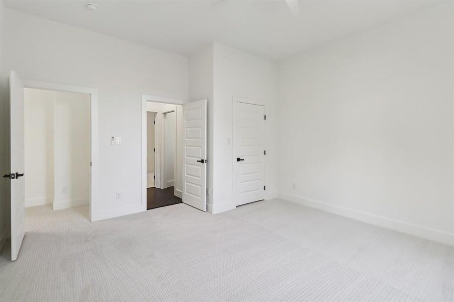 Unfurnished bedroom featuring carpet flooring and baseboards