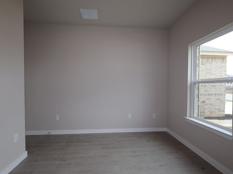 An inviting room boasts fresh flooring and abundant natural light.