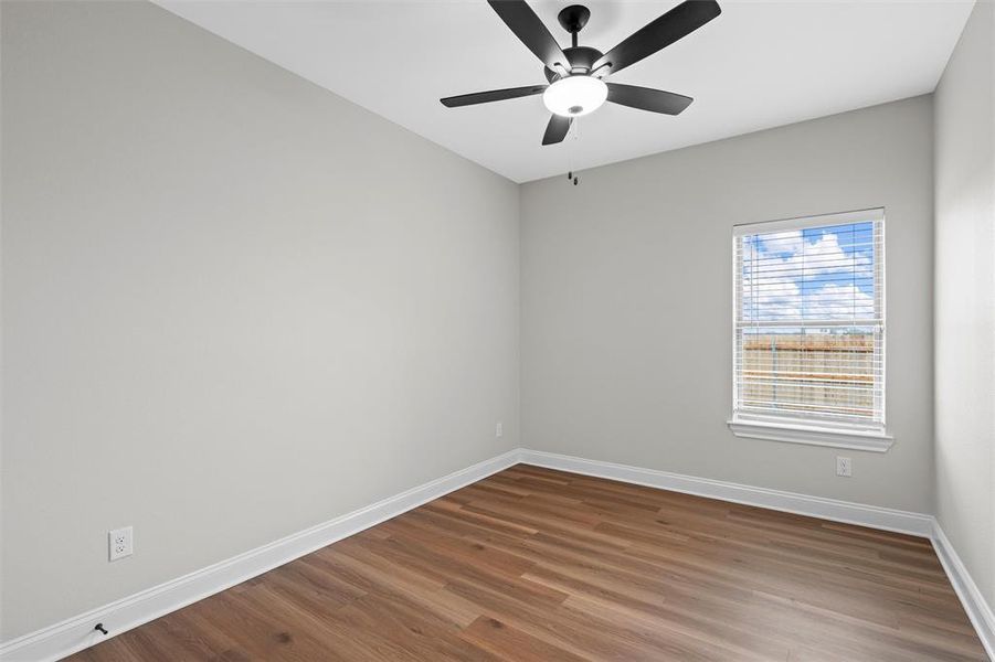 Spare room featuring dark wood finished floors and ceiling fan Spare room featuring dark wood finished floors and ceiling fan
