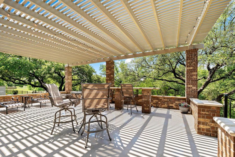 An inviting outdoor patio, perfect for enjoying shaded relaxation and picturesque natural views. An inviting outdoor patio, perfect for enjoying shaded relaxation and picturesque natural views.