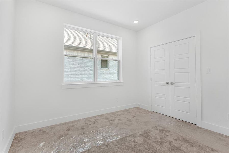 Unfurnished bedroom with carpet floors and a closet