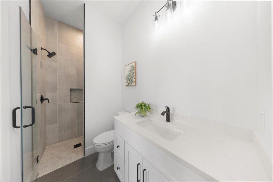 Bathroom featuring a shower stall, vanity, and tile patterned floors Bathroom featuring a shower stall, vanity, and tile patterned floors