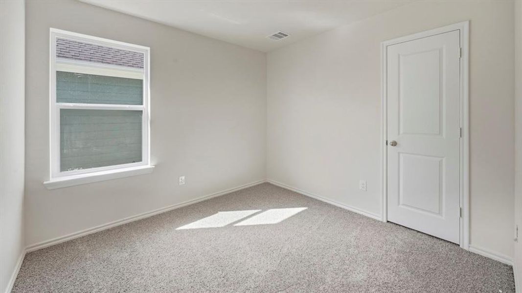 Unfurnished room with light colored carpet and baseboards
